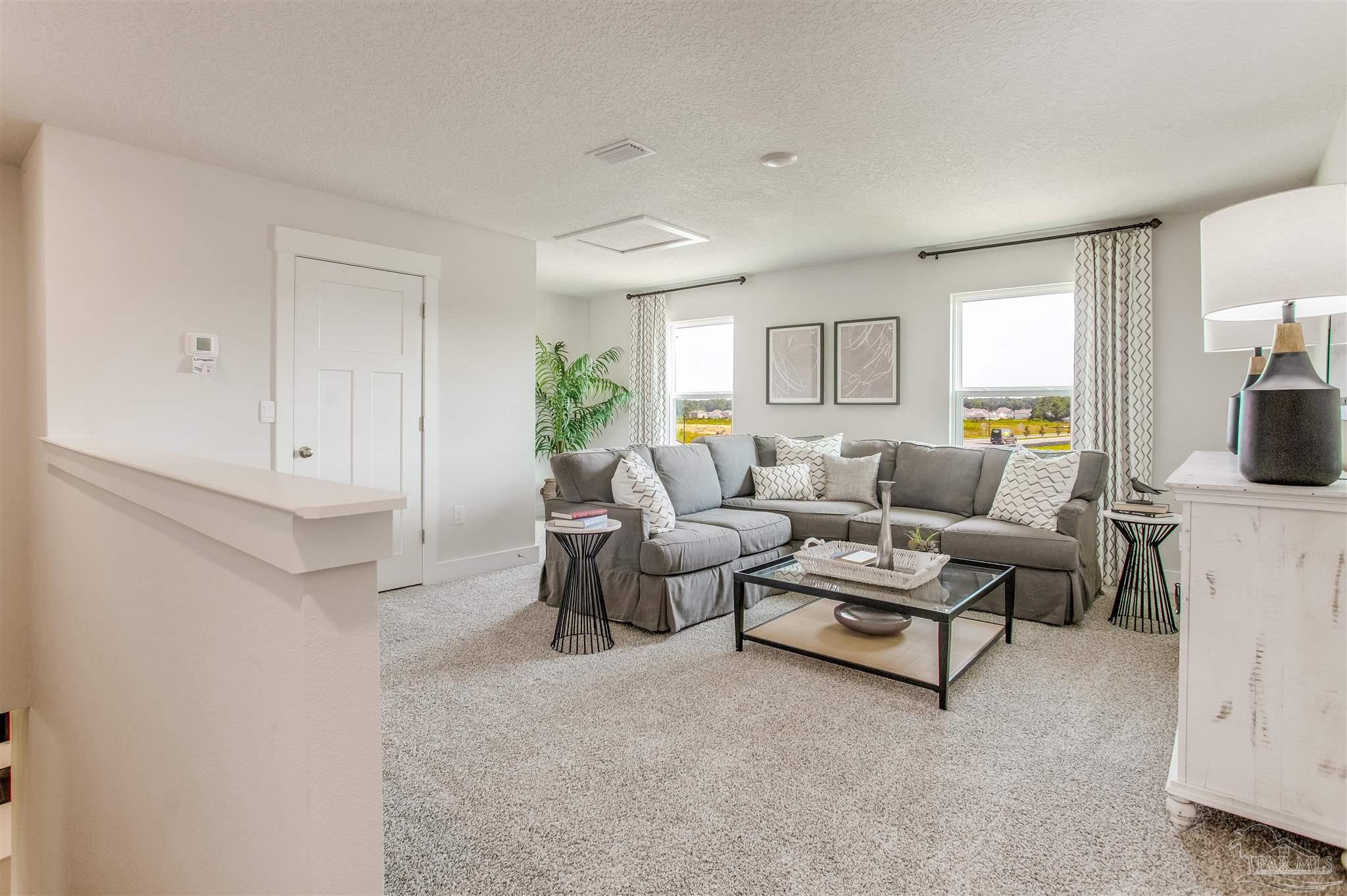 3452 Serviceberry Road Cantonment, FL 32533 - Photo 20 of 38 a living room with furniture and a fireplace