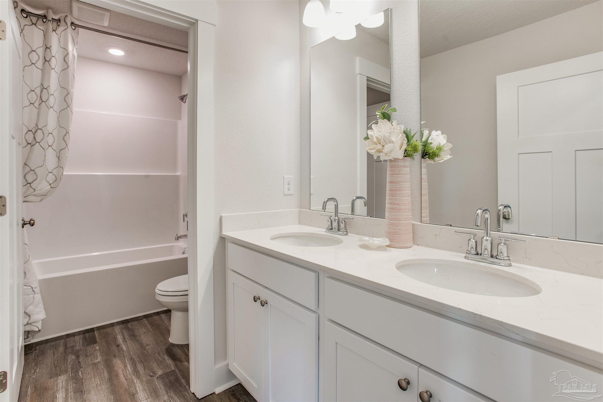 3452 Serviceberry Road Cantonment, FL 32533 - Photo 23 of 38 a bathroom with a tub sink and mirror