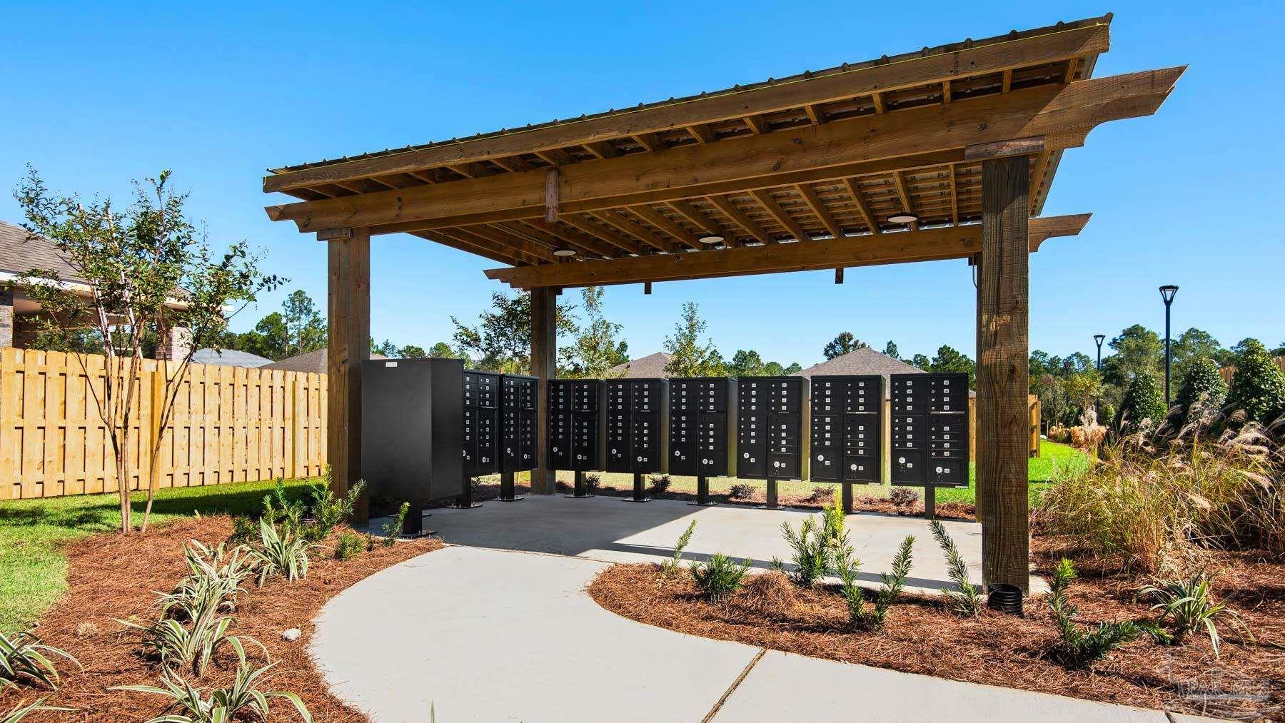 3452 Serviceberry Road Cantonment, FL 32533 - Photo 37 of 38 a view of a patio with a table and chairs under an umbrella