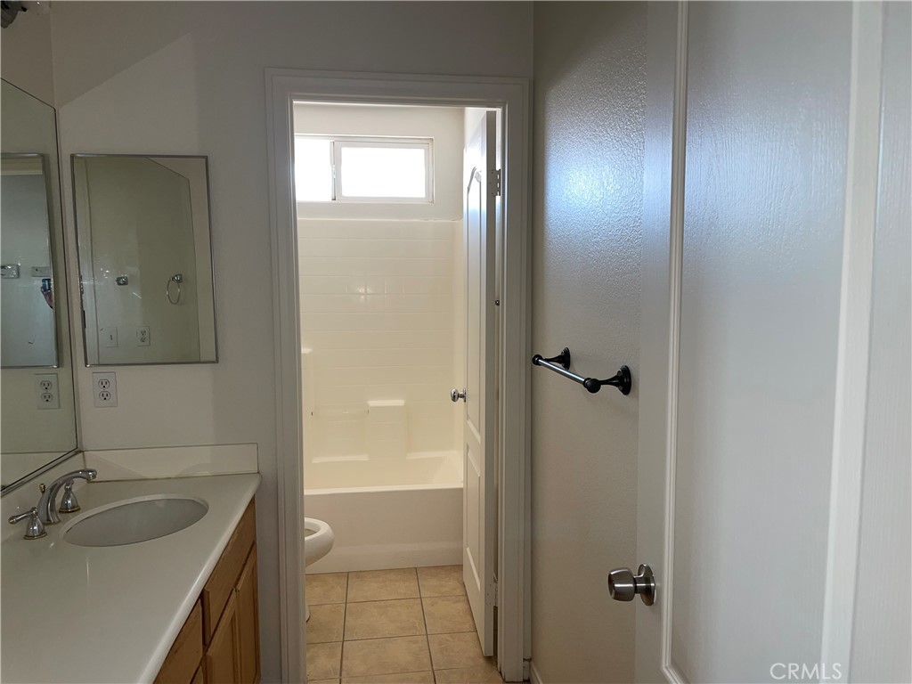 12661 Luna Road Victorville, CA 92392 - Photo 18 of 20 a bathroom with a tub sink vanity granite and shower