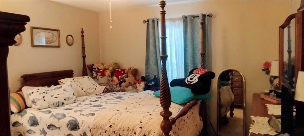 106 Gettysburg Place Atlanta, GA 30350 - Photo 12 of 15 a bedroom with a bed and a chandelier