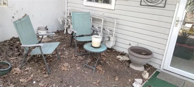 a view of a chairs and table in backyard