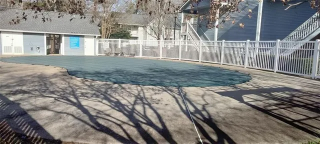 a view of a house with backyard and trees