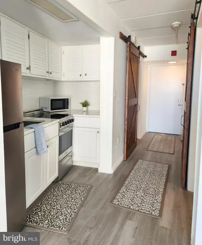 a kitchen with stainless steel appliances a refrigerator sink and cabinets