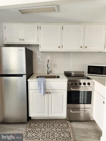 a kitchen with a stove and a refrigerator