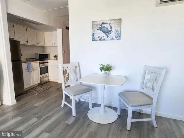 a view of kitchen with cabinets table and chairs