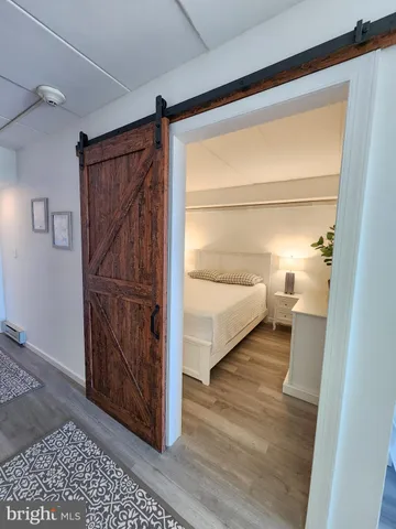 a view of a bedroom with wooden floor and bedroom