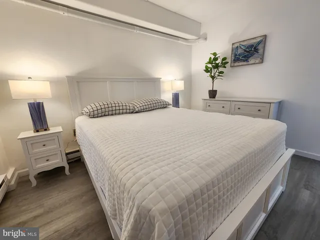 a bedroom with a bed and a night stand