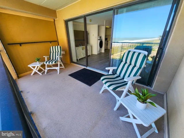 a view of an chairs in the balcony