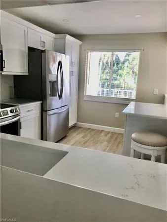 a kitchen with stainless steel appliances a refrigerator sink and stove