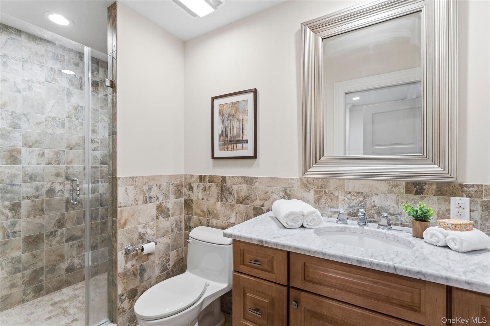 1960 Midlane Road South Syosset, NY 11791 - Photo 33 of 46 a bathroom with a granite countertop sink mirror vanity and toilet