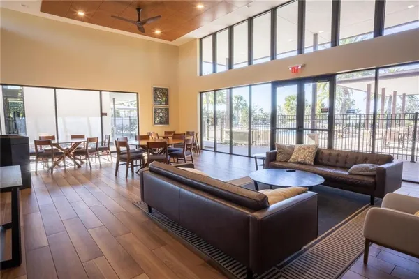 a living room with furniture and floor to ceiling windows