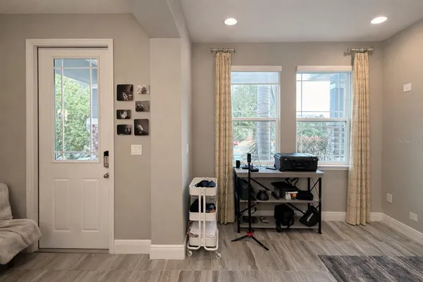 a view of a workspace with wooden floor and a window