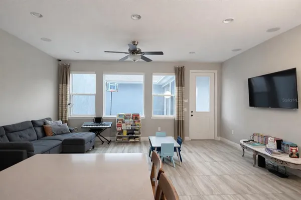 a living room with furniture flat screen tv and wooden floor