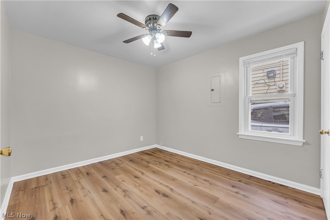 18517 Homeway Road Cleveland, OH 44135 - Photo 14 of 29 Room featuring wood-finish flooring, light gray walls, white trim, and a ceiling fan with integrated lighting