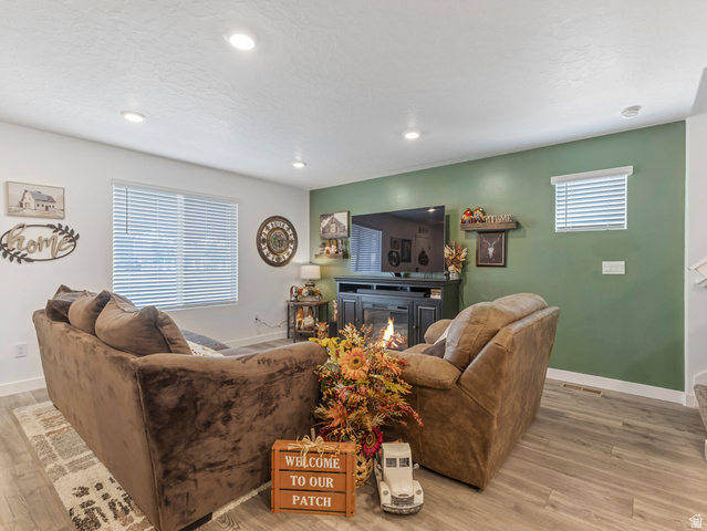 842 North Old Rnch Road Lehi, UT 84048 - Photo 4 of 17 Spacious living area featuring wood-finish flooring, recessed lighting, and large windows with blinds