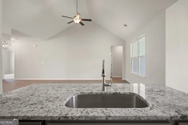 a kitchen with kitchen island a sink stainless steel appliances and a counter top