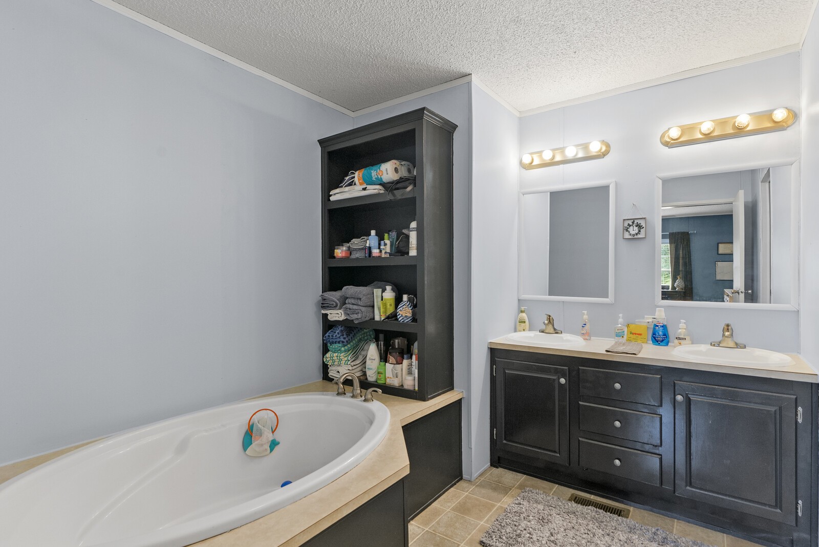 655 Shipper Road Lebanon, TN 37087 - Photo 14 of 32 a bathroom with a tub sink and mirror