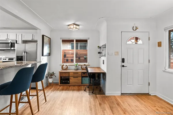 a view of a workspace room with furniture and wooden floor