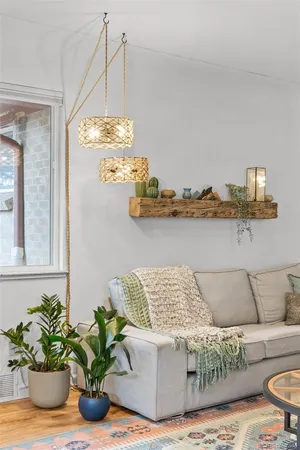 a living room with a couch and potted plant