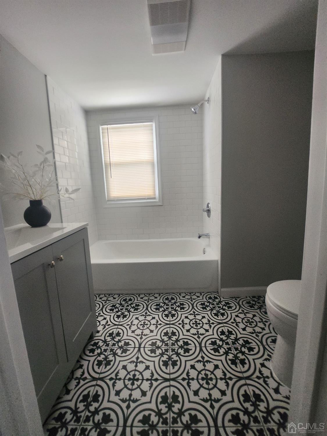 190 Berkeley Terrace Plainfield, NJ 07062 - Photo 13 of 23 a bathroom with a sink a toilet and a window