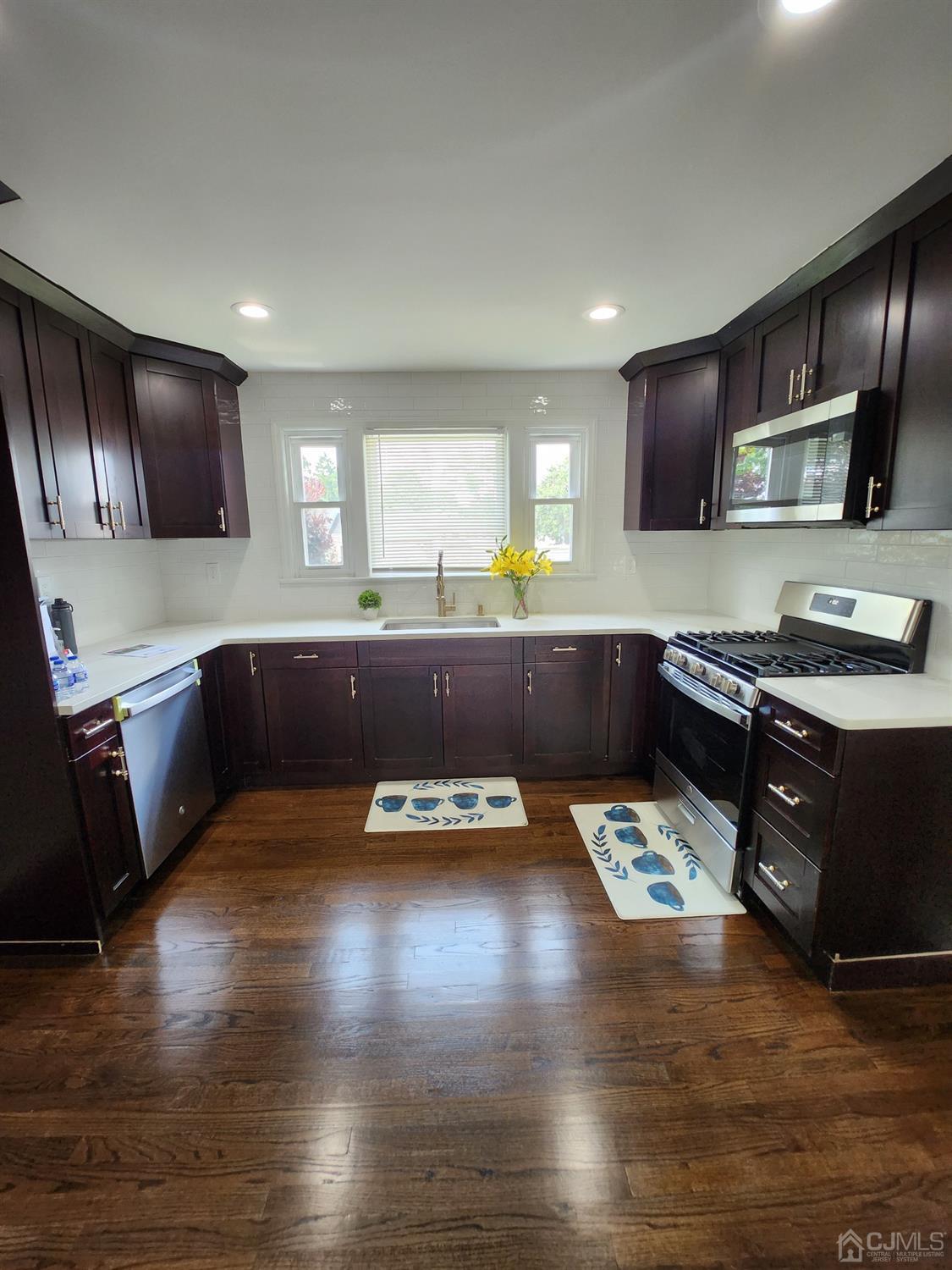 190 Berkeley Terrace Plainfield, NJ 07062 - Photo 3 of 23 a kitchen with stainless steel appliances granite countertop a sink and a stove top oven