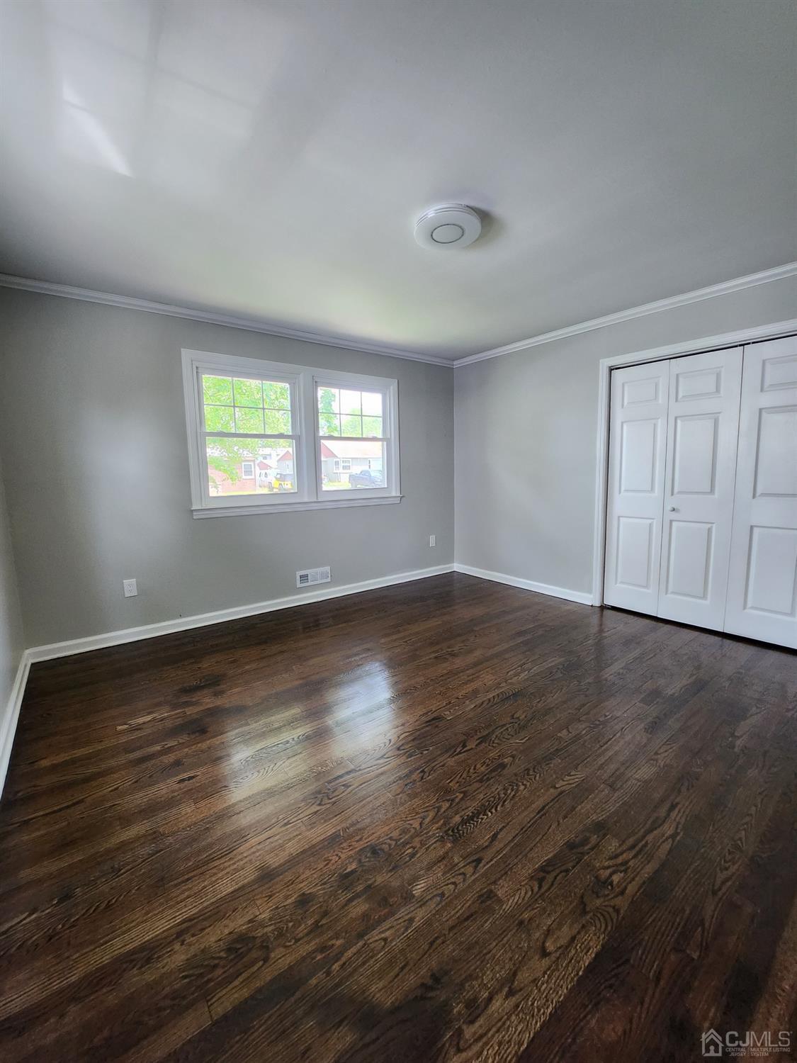190 Berkeley Terrace Plainfield, NJ 07062 - Photo 7 of 23 an empty room with wooden floor and windows