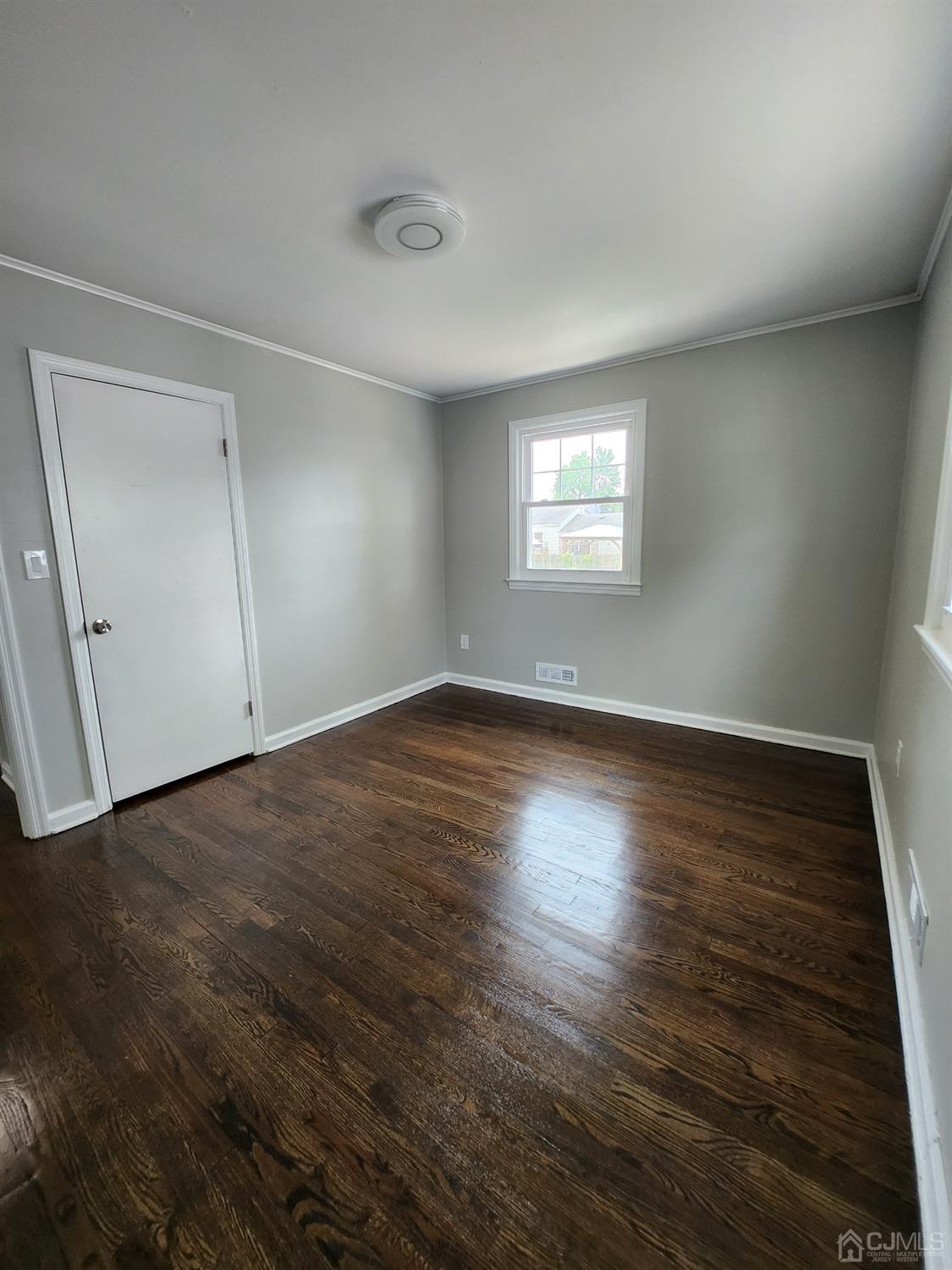 190 Berkeley Terrace Plainfield, NJ 07062 - Photo 9 of 23 an empty room with wooden floor and windows