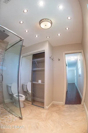 a spacious bedroom with a bed and a window