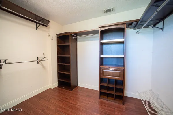 a bathroom with a mirror vanity and a glass door shower