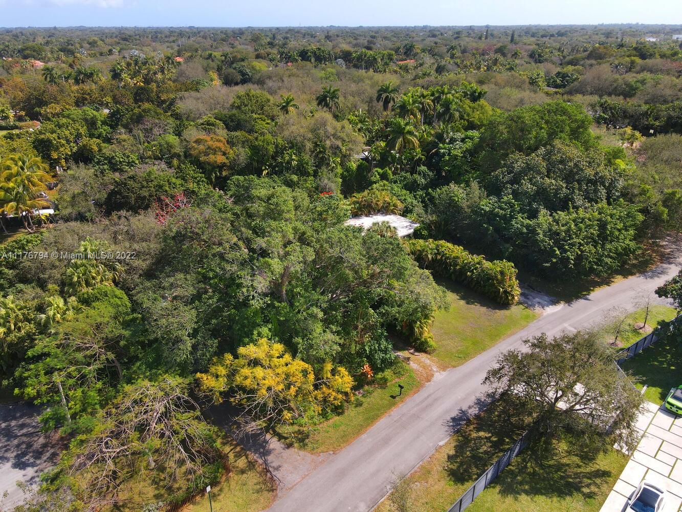 11301 Southwest 80th Road Pinecrest, FL 33156 - Photo 11 of 15 an aerial view of a house with a yard