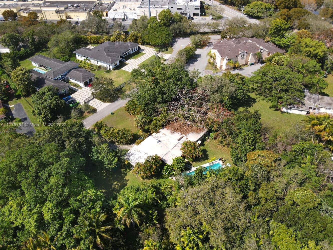 11301 Southwest 80th Road Pinecrest, FL 33156 - Photo 14 of 15 an aerial view of residential houses with outdoor space and trees all around