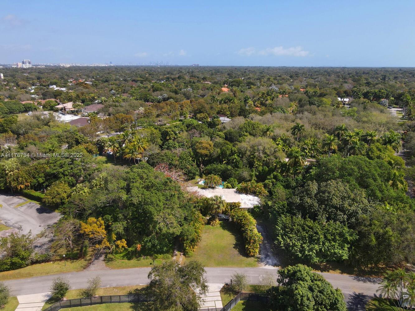 11301 Southwest 80th Road Pinecrest, FL 33156 - Photo 8 of 15 an aerial view of residential houses with outdoor space and trees