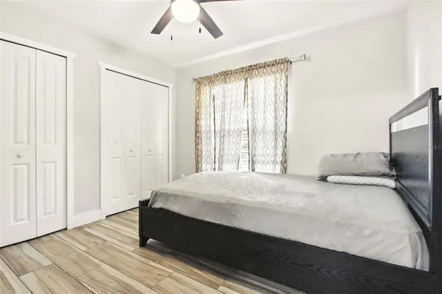 a bedroom with a bed and wooden floor