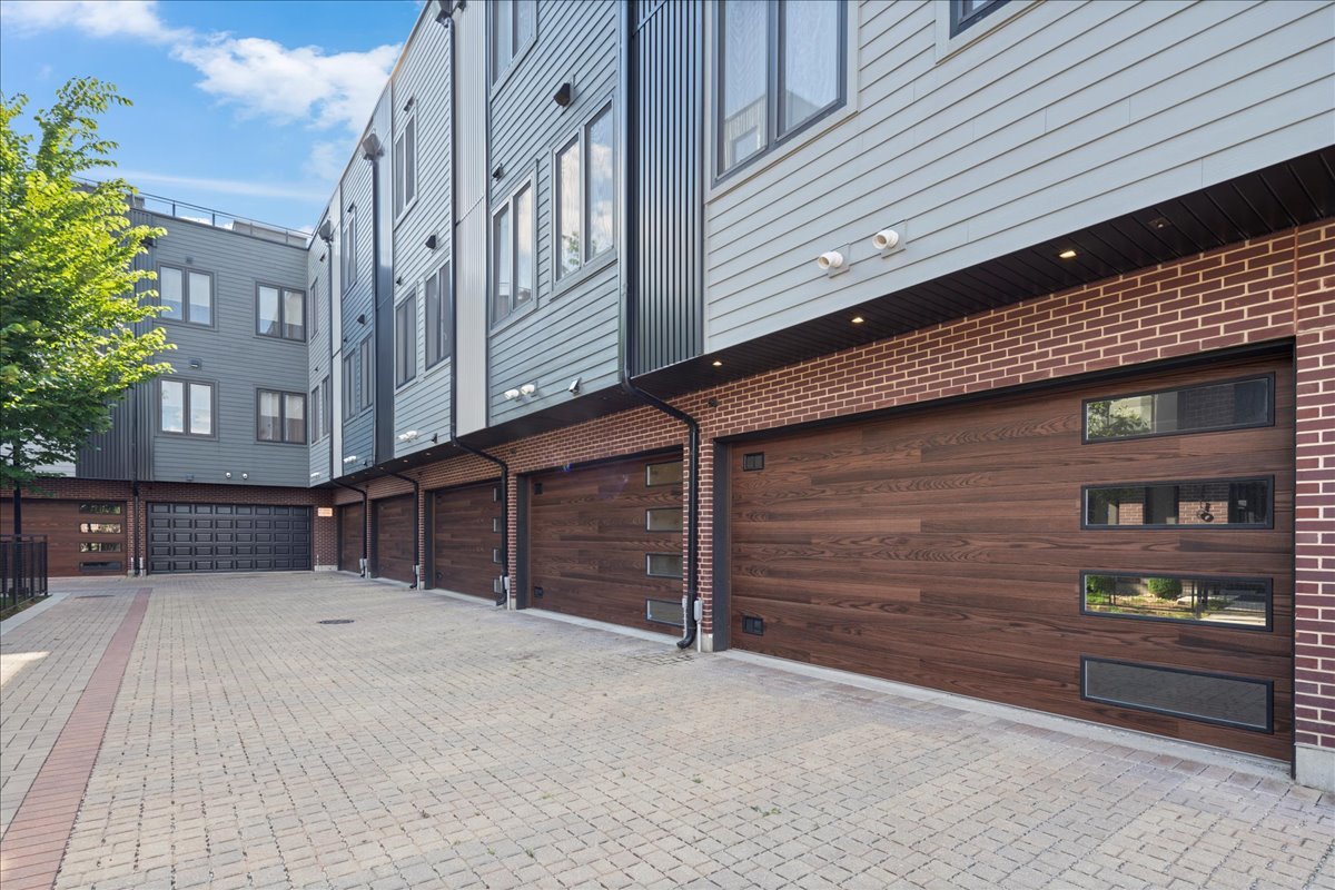4232 West Belmont Avenue, Unit 2 Chicago, IL 60641 - Photo 31 of 35 a view of a house with a wooden bench