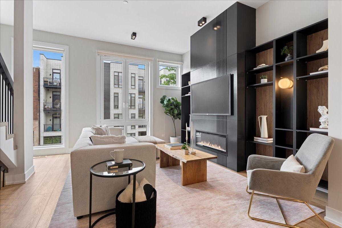 4232 West Belmont Avenue, Unit 2 Chicago, IL 60641 - Photo 4 of 35 a living room with furniture a large window and kitchen view