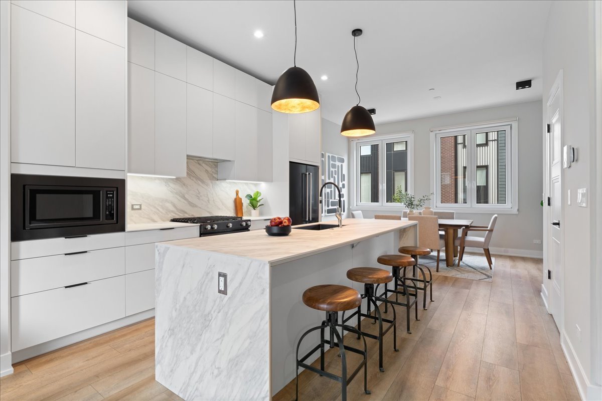 4232 West Belmont Avenue, Unit 2 Chicago, IL 60641 - Photo 9 of 35 a kitchen with cabinets and wooden floor