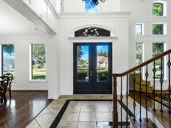 a living room with furniture a fireplace and a dining table with kitchen view