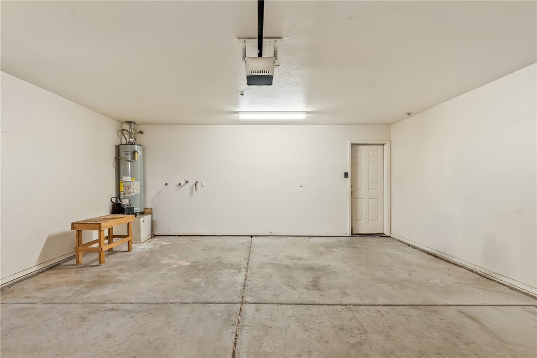 2853 Winchester Road Bullhead City, AZ 86442 - Photo 29 of 40 Spacious garage with light-colored walls, concrete flooring, and a white door