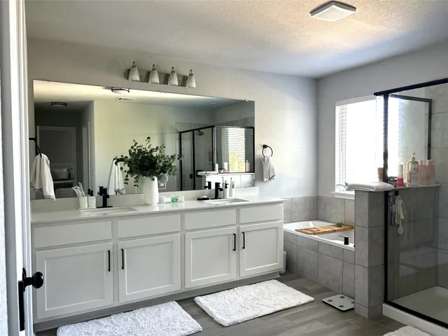 a bathroom with a double vanity sink and a mirror