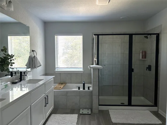 a large bed sitting in a bedroom next to a window and a lamp