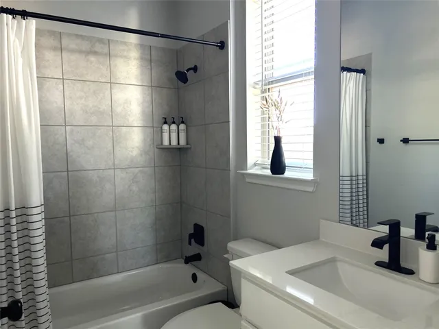 a kitchen with granite countertop a table chairs stove a sink and dishwasher