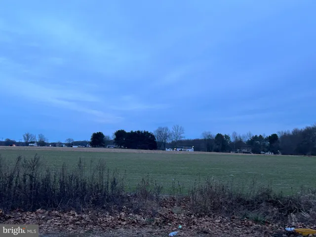 a view of a lake and green valley