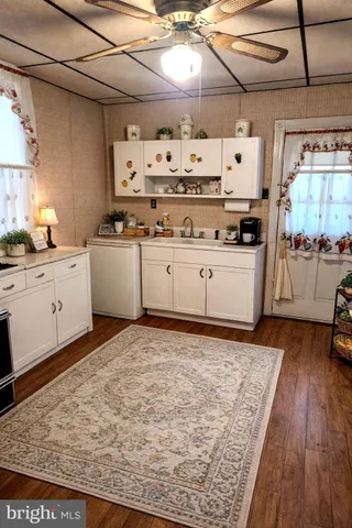 a kitchen with granite countertop a sink and cabinets