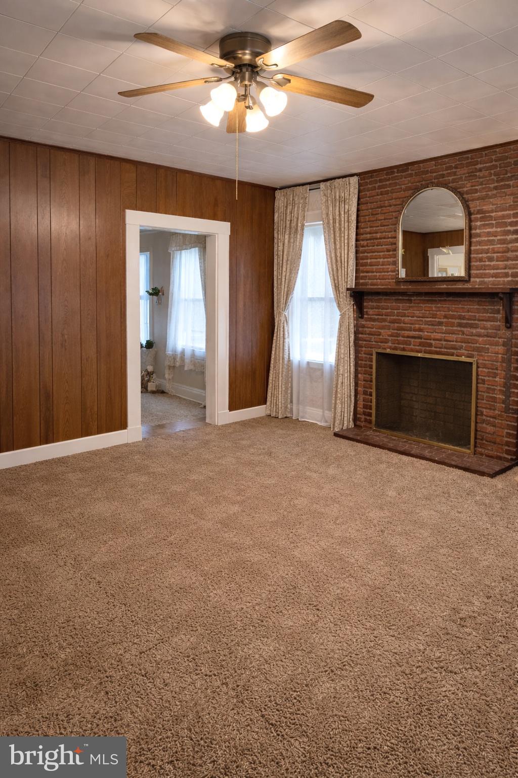 3612 6th Street Baltimore, MD 21225 - Photo 3 of 5 a view of an empty room with a fireplace and a window