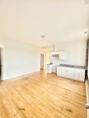 a view of a kitchen with kitchen island a sink and a stove
