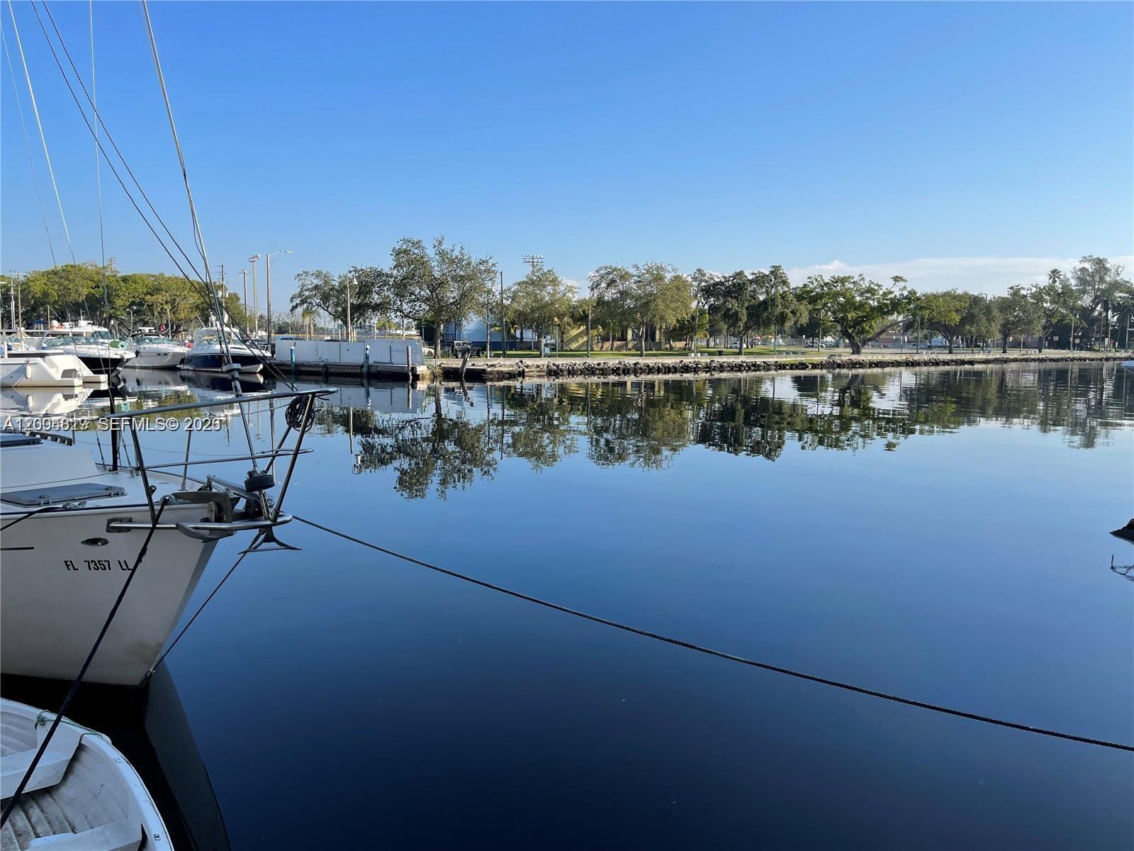 2415 Northwest 16th St Road, Unit 102 Miami, FL 33125 - Photo 19 of 19 a view of a lake with boats and trees in the background