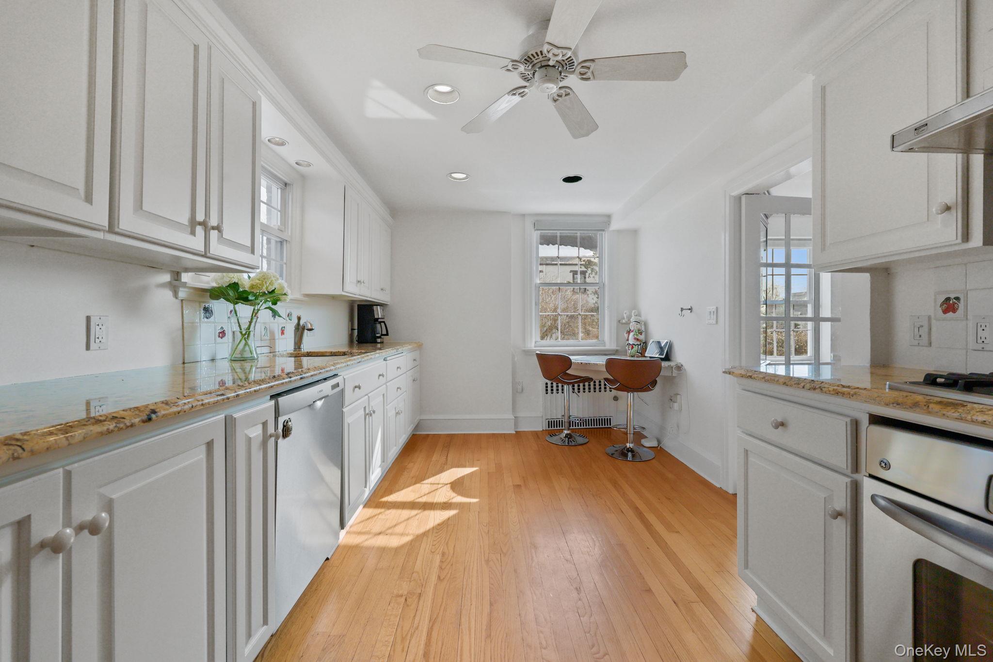 401 Heathcote Road Scarsdale, NY 10583 - Photo 11 of 41 a kitchen with sink cabinets and window