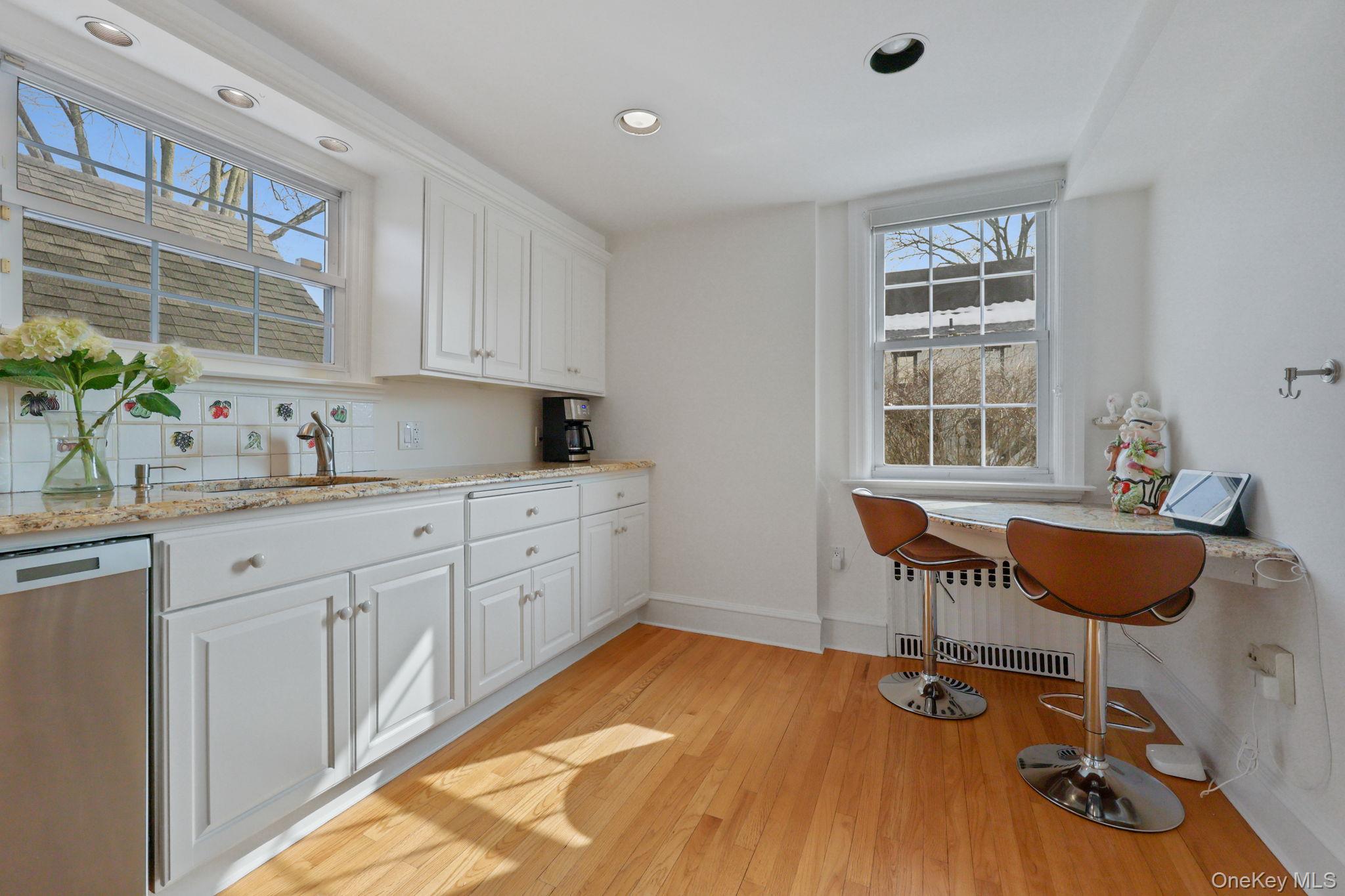 401 Heathcote Road Scarsdale, NY 10583 - Photo 12 of 41 a kitchen with a table chairs stove and cabinets