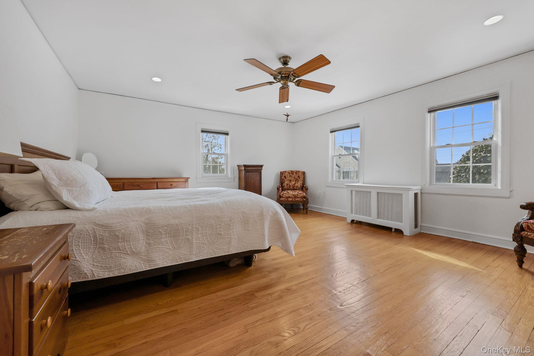 401 Heathcote Road Scarsdale, NY 10583 - Photo 16 of 41 a bedroom with a bed and a window